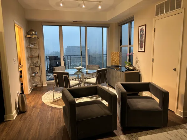 a living room with furniture fireplace and large windows