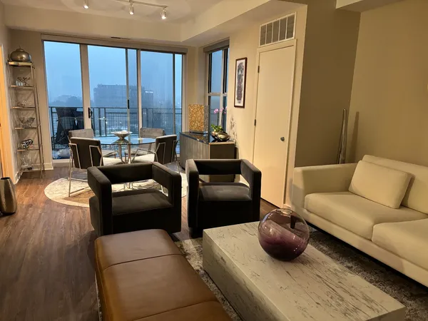 a living room with furniture and floor to ceiling windows