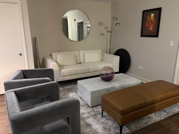 a living room with furniture and a mirror