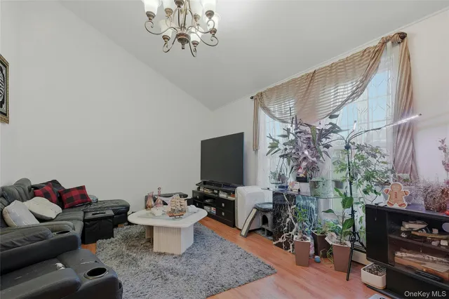 a living room with furniture a rug and a window