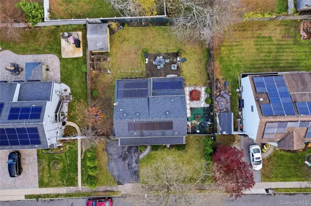 an aerial view of a house with a garden and lake view