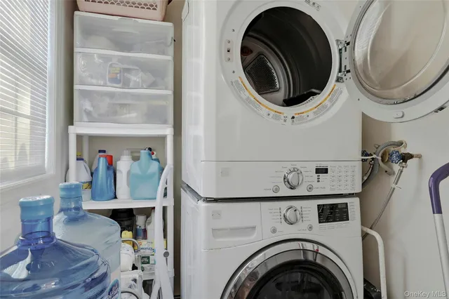 a kitchen with kitchen island granite countertop a sink stove and cabinets