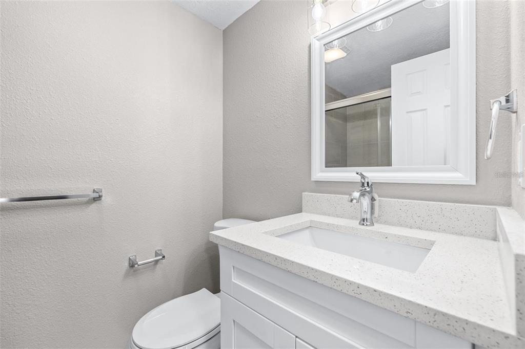 13926 Helen Avenue Hudson, FL 34667 - Photo 12 of 44 a bathroom with a sink toilet and mirror
