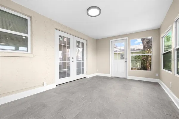 an empty room with windows and entrance
