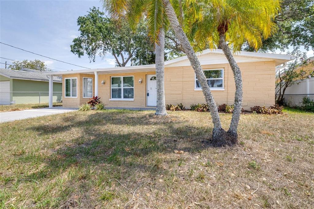 13926 Helen Avenue Hudson, FL 34667 - Photo 2 of 44 a front view of a house with garden