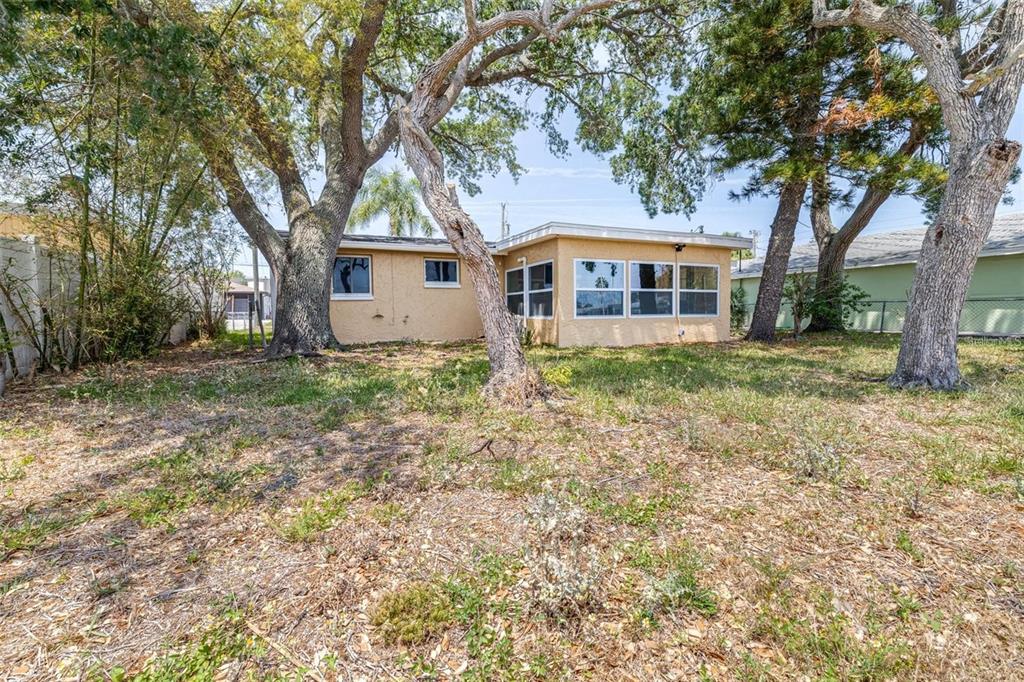 13926 Helen Avenue Hudson, FL 34667 - Photo 24 of 44 a front view of a house with a garden