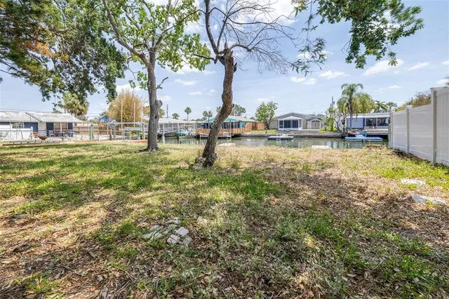 a view of yard with swimming pool and trees