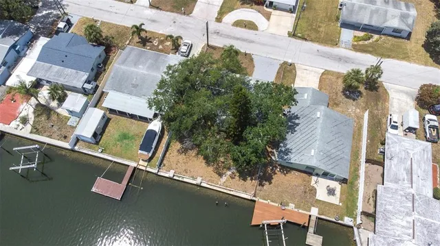 an aerial view of a house with a yard