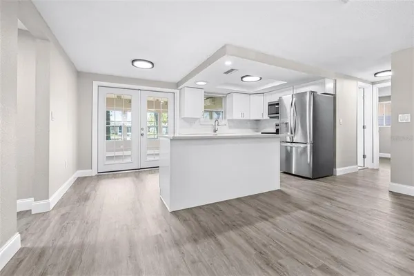 a kitchen with stainless steel appliances granite countertop a refrigerator and a stove top oven