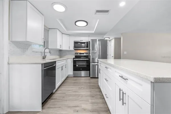 a large kitchen with a stove top oven