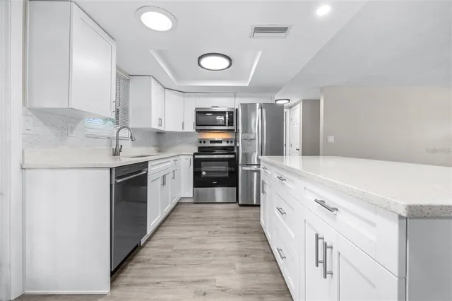 a large kitchen with a stove top oven