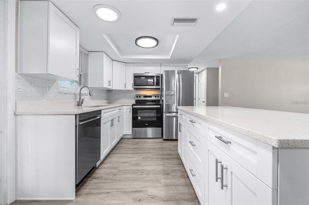 13926 Helen Avenue Hudson, FL 34667 - Photo 7 of 44 a large kitchen with a stove top oven