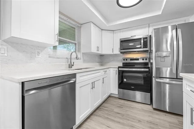 a kitchen with a refrigerator stove and sink