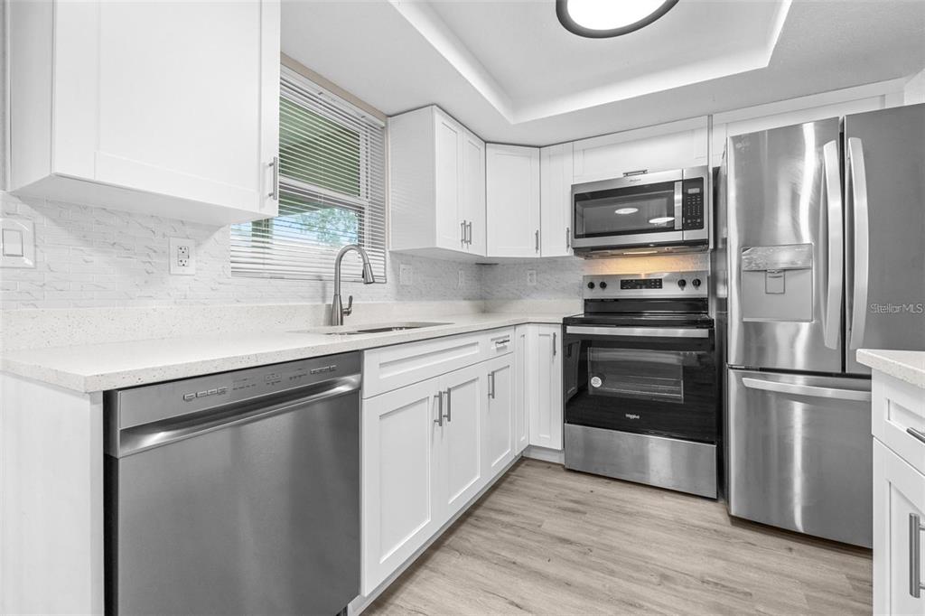 13926 Helen Avenue Hudson, FL 34667 - Photo 10 of 44 a kitchen with a refrigerator stove and sink