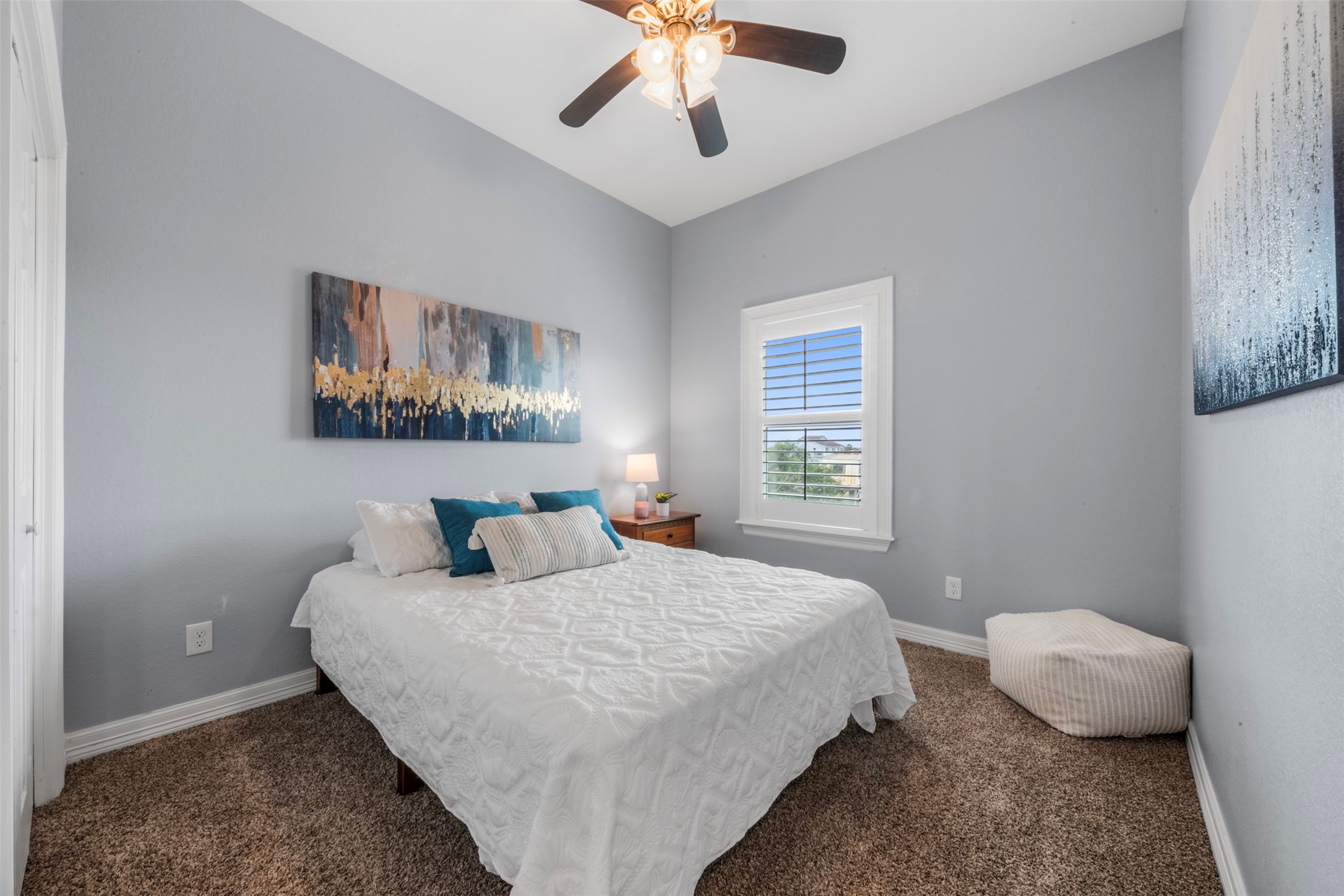 1026 20th Street Dickinson, TX 77539 - Photo 8 of 25 a bedroom with a bed and a chandelier