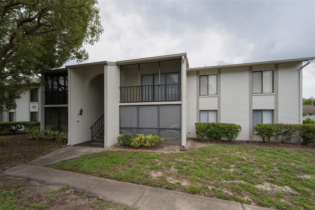 2687 Pine Ridge Way South, Unit B2 Palm Harbor, FL 34684 - Photo 2 of 68 a view of a house with backyard and plants