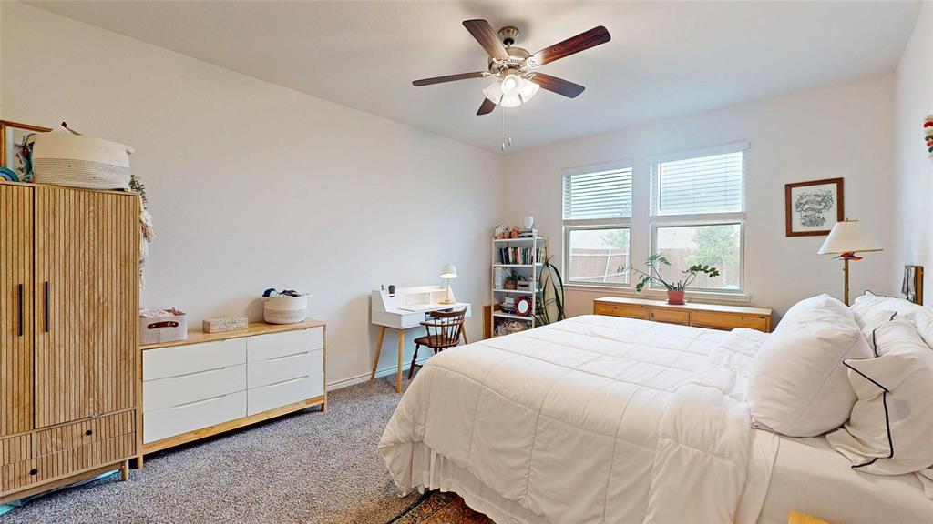 4005 Glastonbury Road McKinney, TX 75071 - Photo 16 of 39 a bedroom with a bed and a chandelier