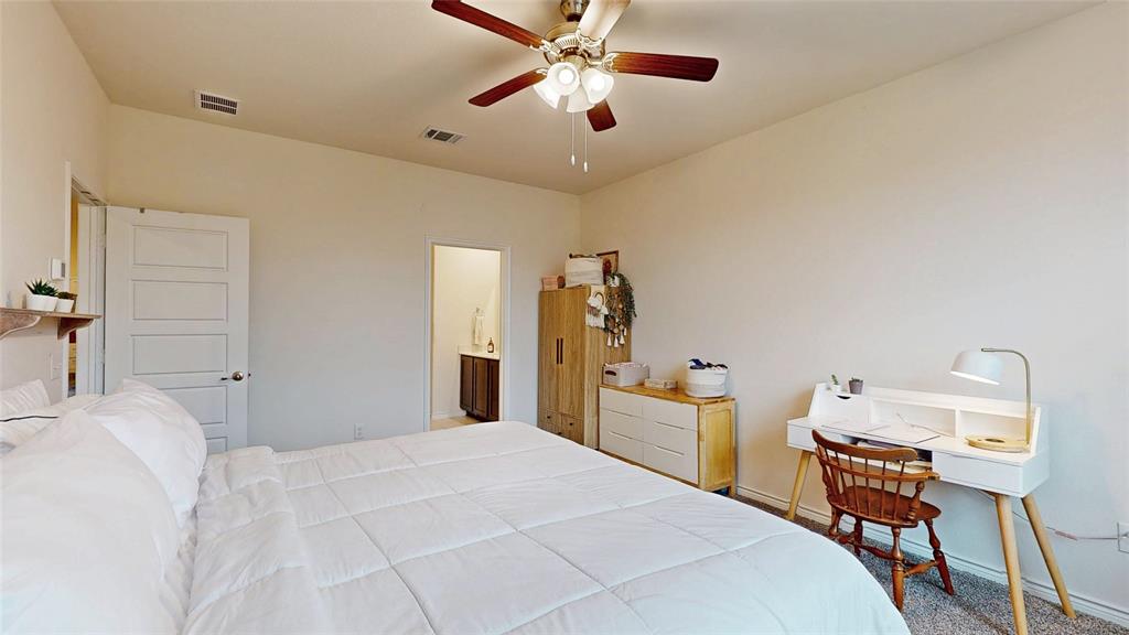 4005 Glastonbury Road McKinney, TX 75071 - Photo 18 of 39 a bedroom with a bed and a chandelier