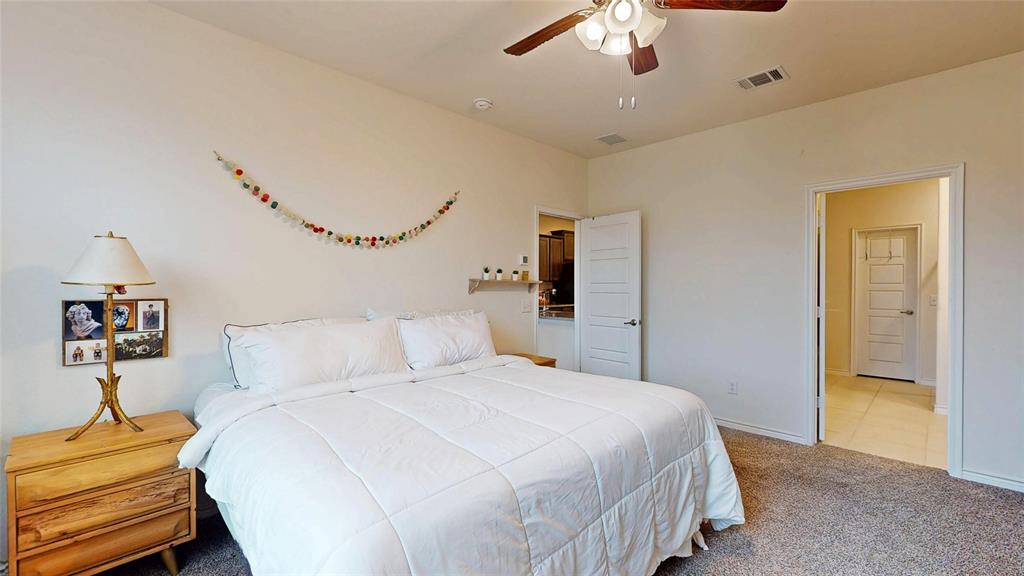 4005 Glastonbury Road McKinney, TX 75071 - Photo 19 of 39 a bedroom with a bed and a chandelier