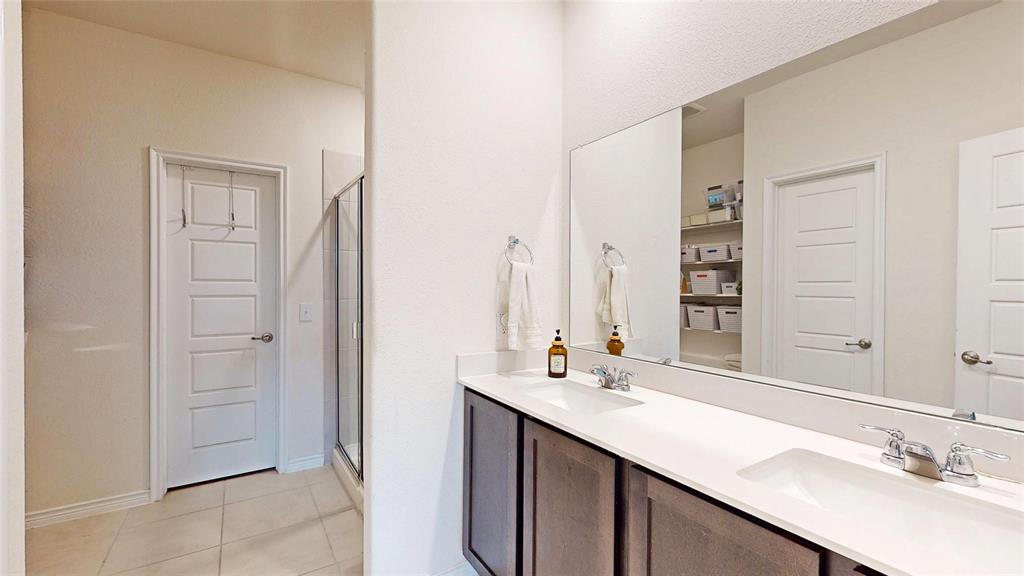 4005 Glastonbury Road McKinney, TX 75071 - Photo 20 of 39 a bathroom with a double vanity sink a and mirror
