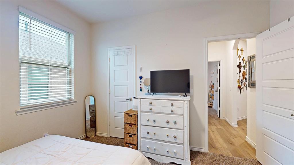 4005 Glastonbury Road McKinney, TX 75071 - Photo 24 of 39 a bedroom with a bed and flat screen tv