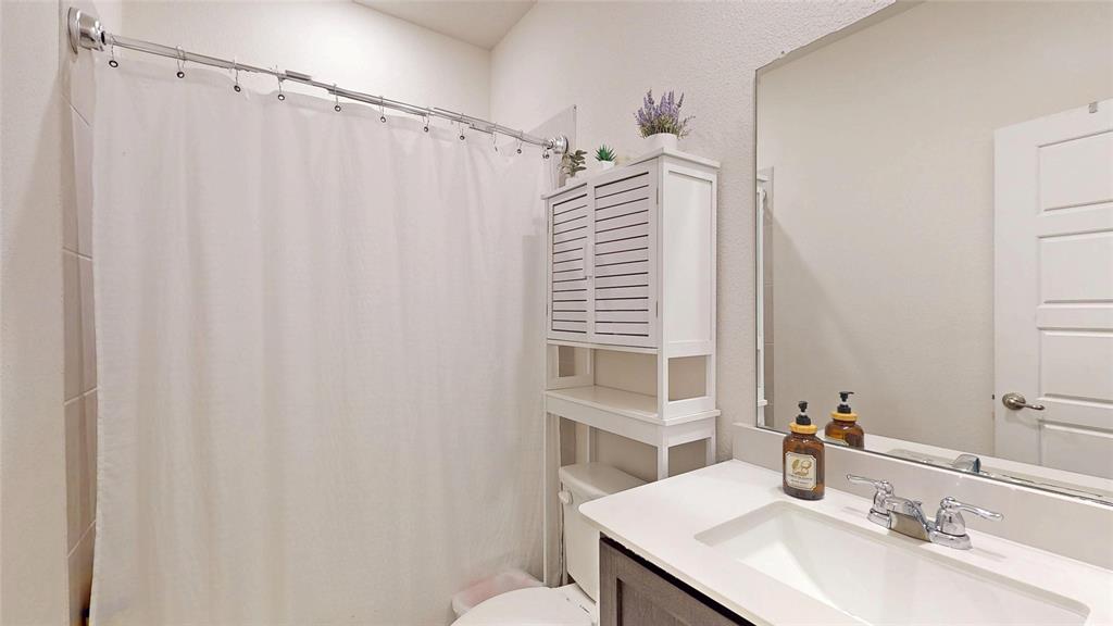4005 Glastonbury Road McKinney, TX 75071 - Photo 25 of 39 a bathroom with a sink and a mirror