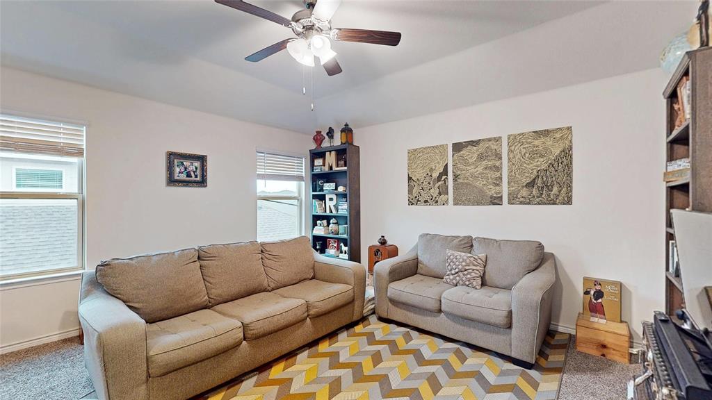 4005 Glastonbury Road McKinney, TX 75071 - Photo 33 of 39 a living room with furniture a ceiling fan and a window