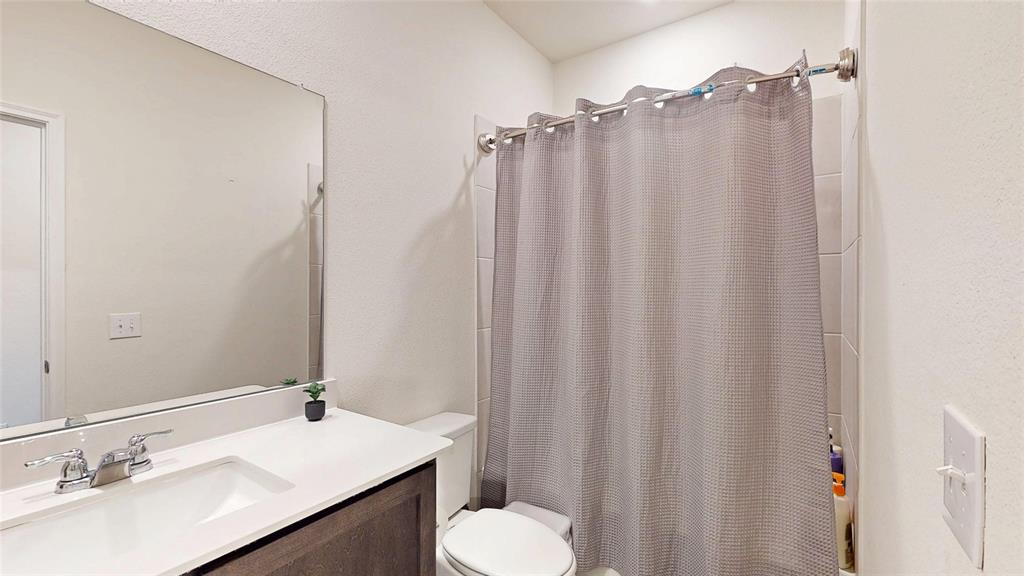 4005 Glastonbury Road McKinney, TX 75071 - Photo 34 of 39 a bathroom with a sink and a mirror
