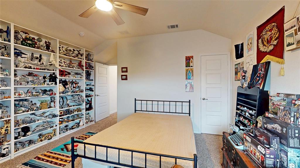 4005 Glastonbury Road McKinney, TX 75071 - Photo 37 of 39 a bedroom with furniture and a book shelf
