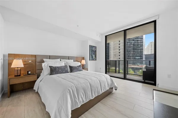 a bedroom with a large bed and a large window