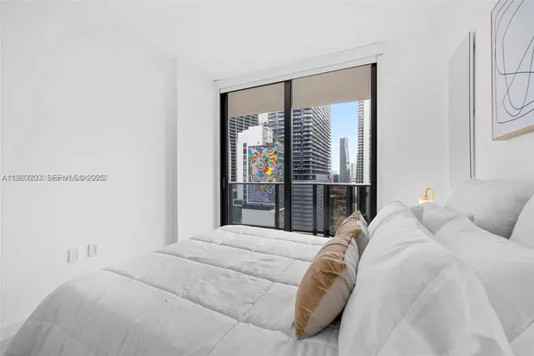 a bedroom with a large bed and a window