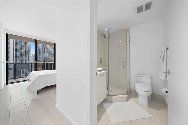 a bathroom with a toilet and a shower