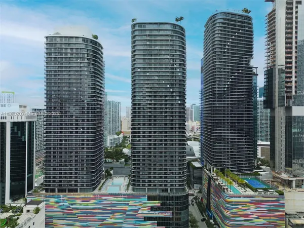 a view of a living room with a black and white kitchen
