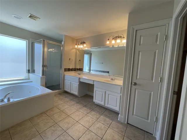 a spacious bathroom with a sink and a mirror