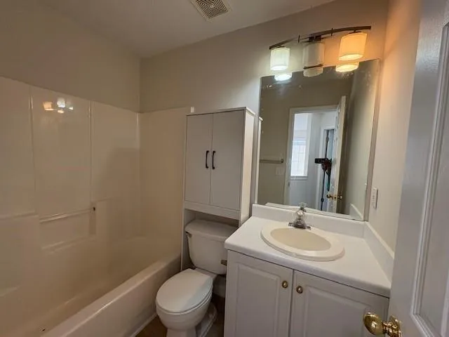 a bathroom with a sink toilet and a mirror