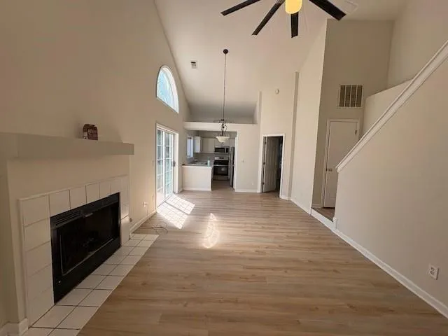 a view of a livingroom with a fireplace and window