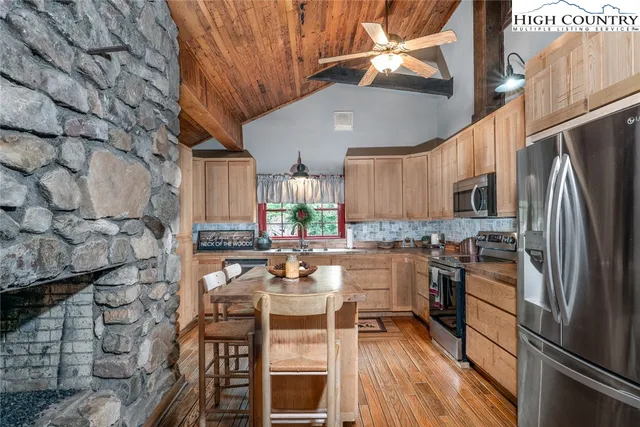 a kitchen with granite countertop lots of counter top space and stainless steel appliances