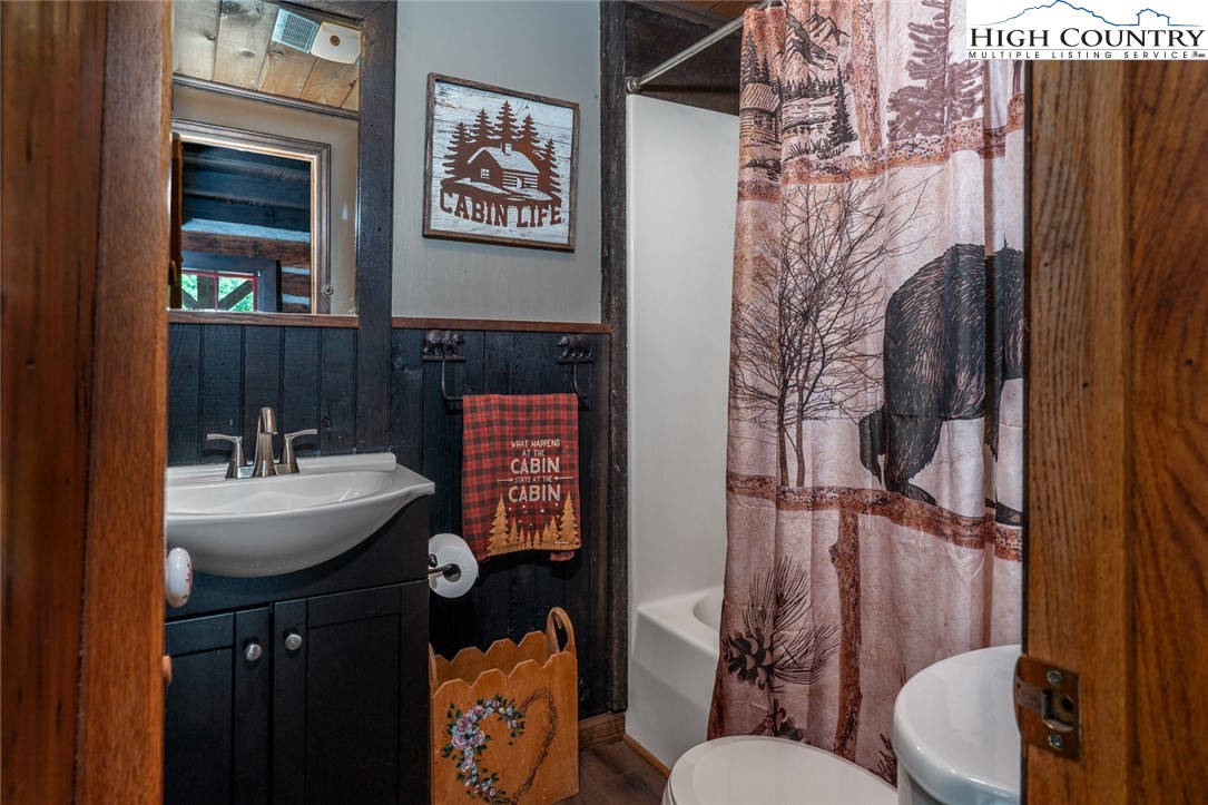 164 Avery Co High School Road Newland, NC 28657 - Photo 17 of 50 a bathroom with a sink and mirror with toilet