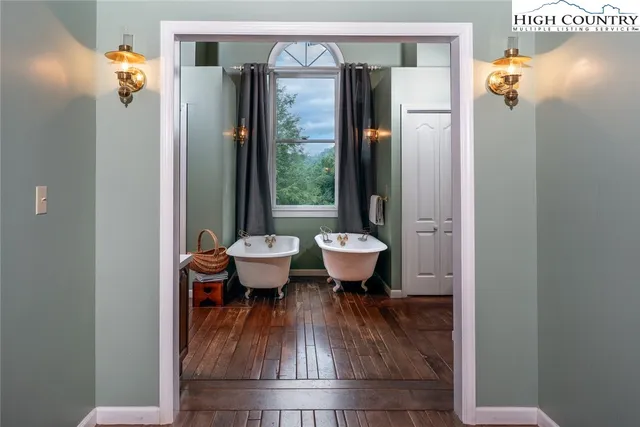 a bathroom with a sink toilet a mirror and bathtub