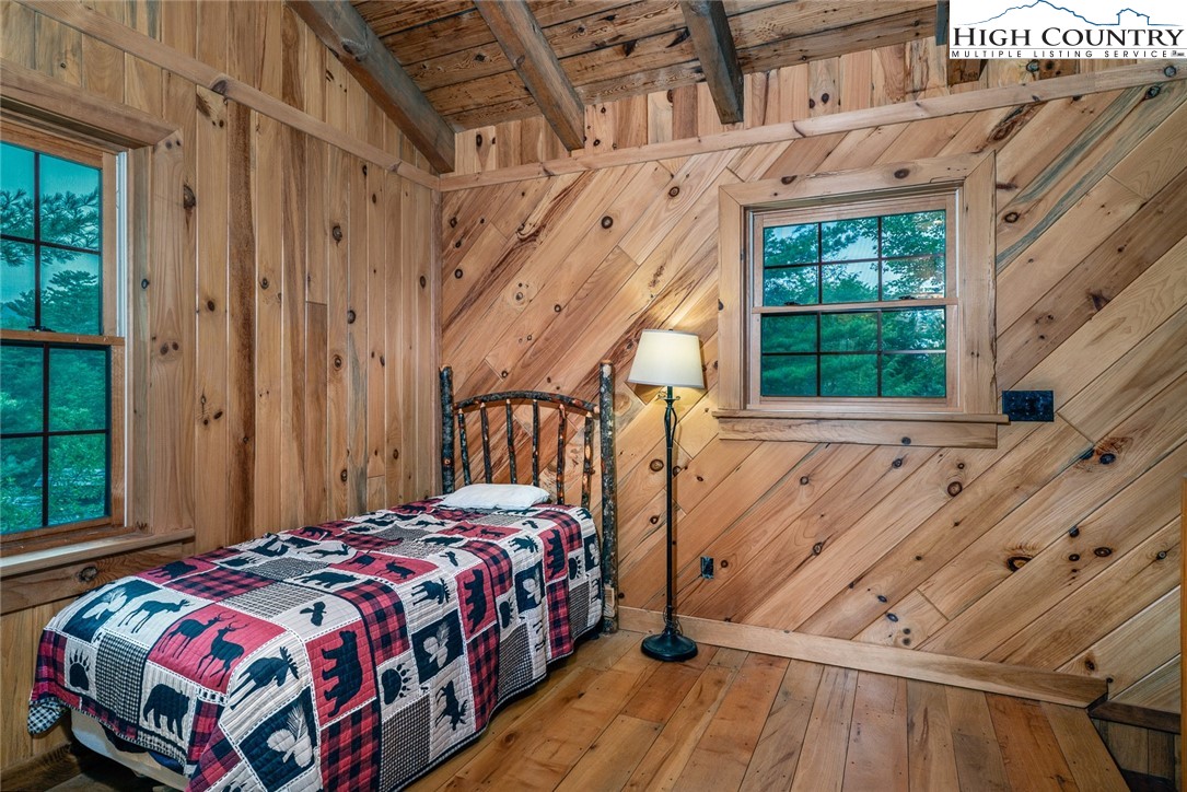 164 Avery Co High School Road Newland, NC 28657 - Photo 39 of 50 a bedroom with a bed next to a window
