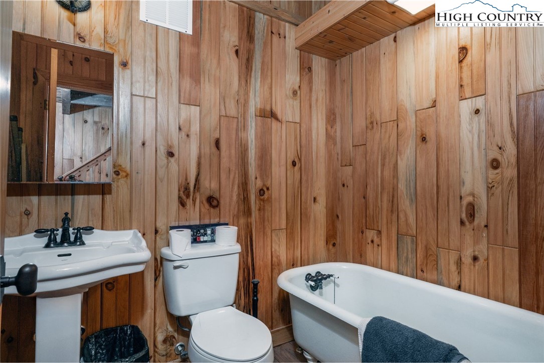 164 Avery Co High School Road Newland, NC 28657 - Photo 40 of 50 a bathroom with a sink a toilet and shower curtain