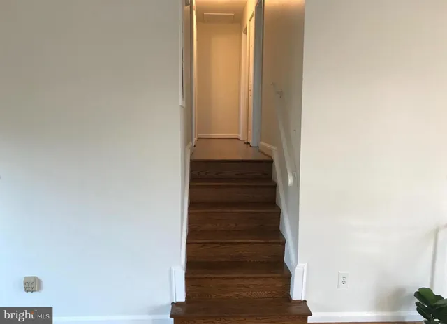 a view of staircase with white walls