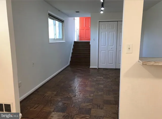 a view of hallway with window and stairs