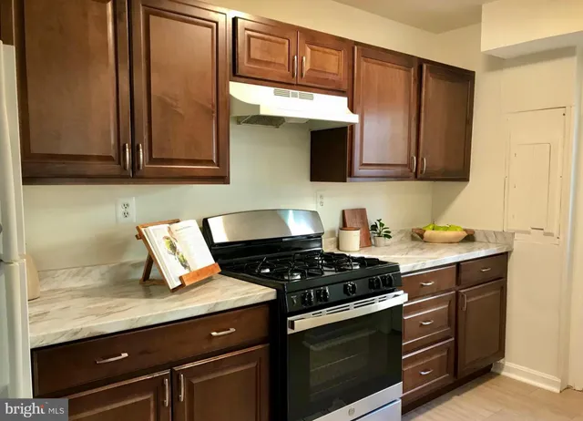 a kitchen with stainless steel appliances granite countertop a stove and a microwave
