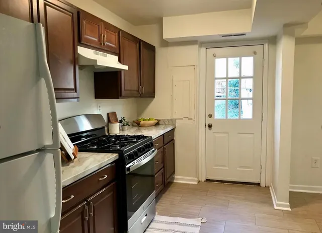 a kitchen with stainless steel appliances granite countertop a stove and a microwave