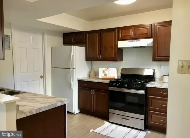 a kitchen with a stove and a refrigerator