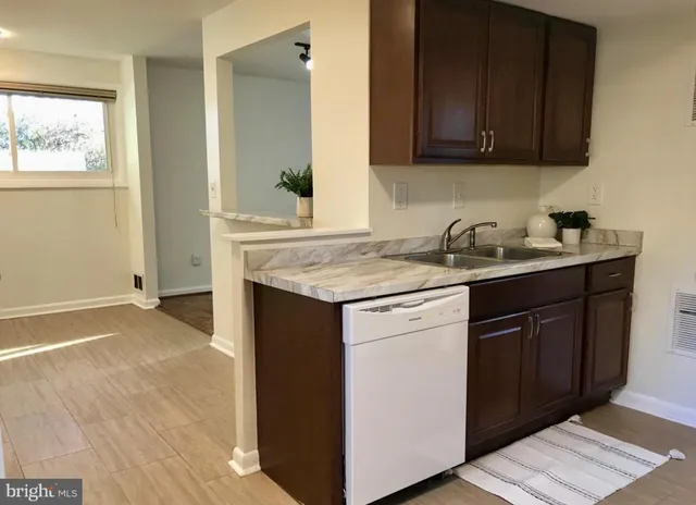 a kitchen with granite countertop cabinets sink and stove