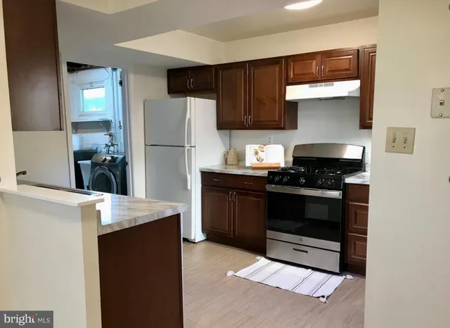 a kitchen with a refrigerator and a stove