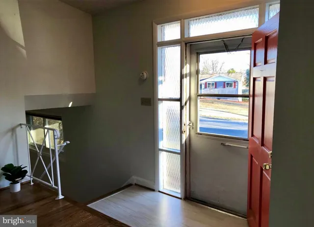 a view of an entryway with wooden floor