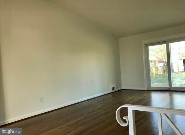 a view of room with window and wooden floor